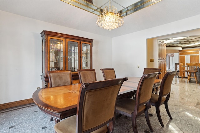 dining area featuring an inviting chandelier