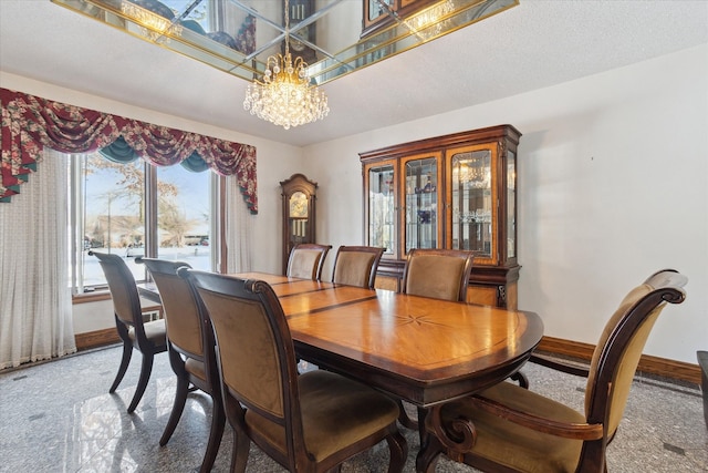 dining area featuring carpet floors, a textured ceiling, and a chandelier