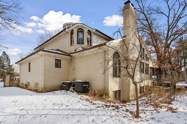 view of snow covered back of property