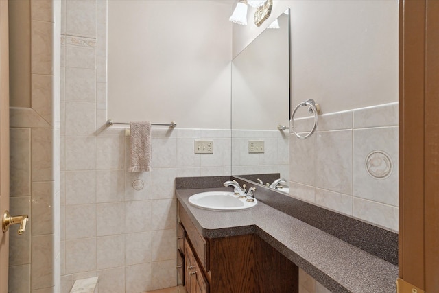 bathroom with vanity and tile walls