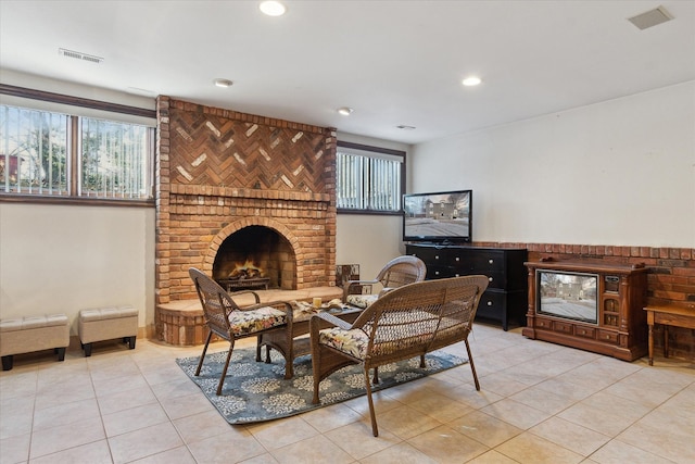 sitting room featuring light tile patterned floors and a fireplace