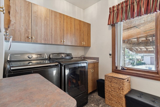 laundry area featuring cabinets, sink, and washer and clothes dryer