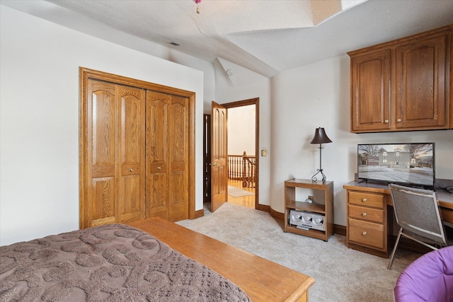 bedroom featuring light carpet and a closet