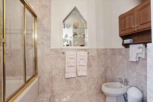 bathroom featuring a bidet, tile walls, and shower / bath combination with glass door