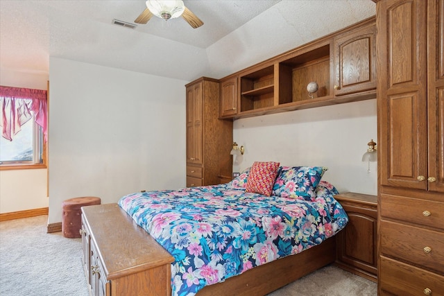 bedroom featuring ceiling fan and light colored carpet