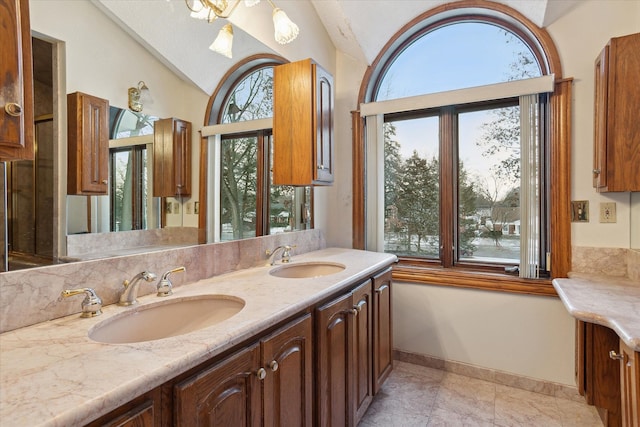 bathroom featuring vanity and lofted ceiling