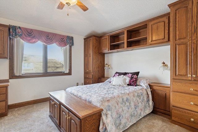 bedroom with light carpet, a textured ceiling, and ceiling fan