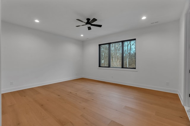 empty room with light hardwood / wood-style floors and ceiling fan