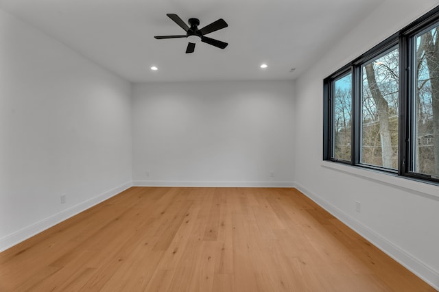 unfurnished room featuring light hardwood / wood-style flooring, ceiling fan, and plenty of natural light