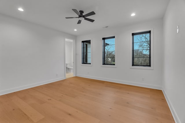 empty room featuring light wood-type flooring and ceiling fan