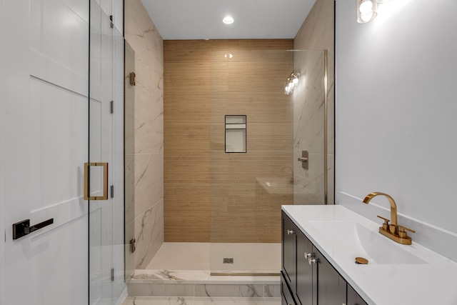 bathroom featuring vanity and a shower with door