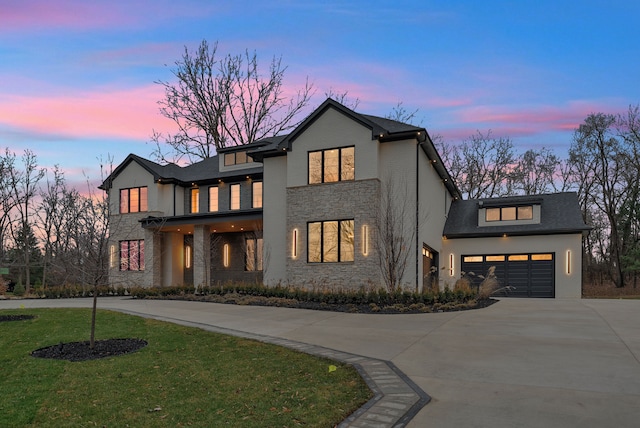 view of front of house featuring a garage and a yard