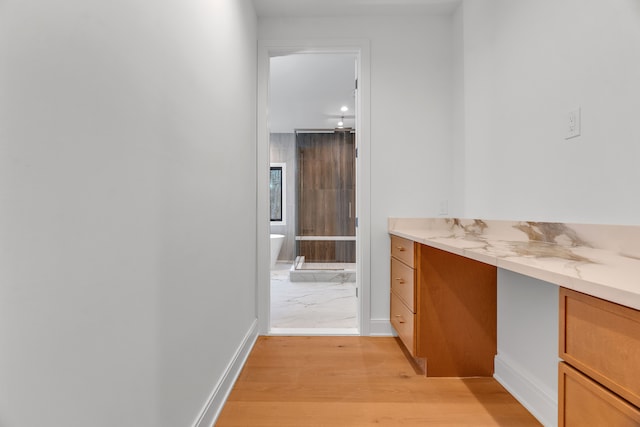 bathroom with hardwood / wood-style floors, a washtub, and vanity