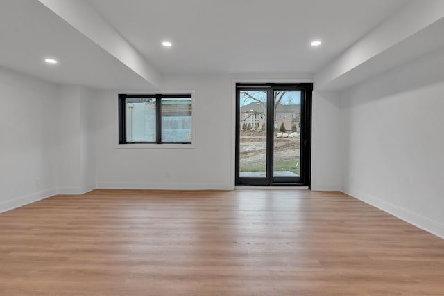 unfurnished room with light wood-type flooring and a healthy amount of sunlight