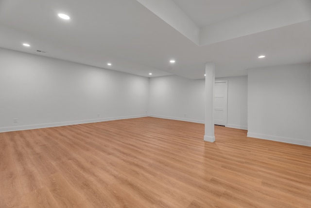 basement with light hardwood / wood-style floors