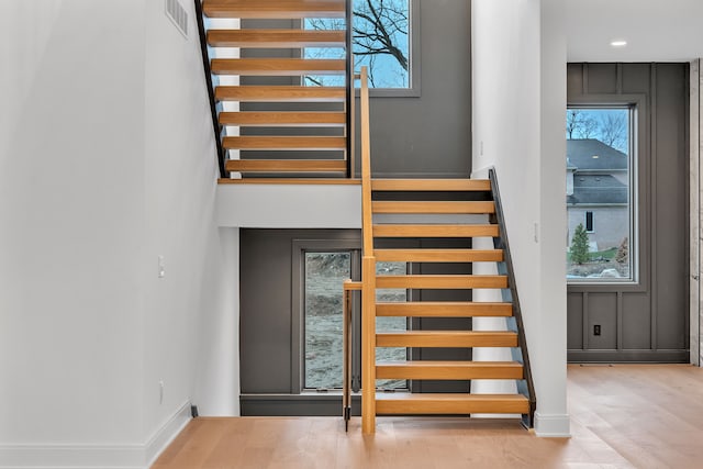 stairway with hardwood / wood-style floors