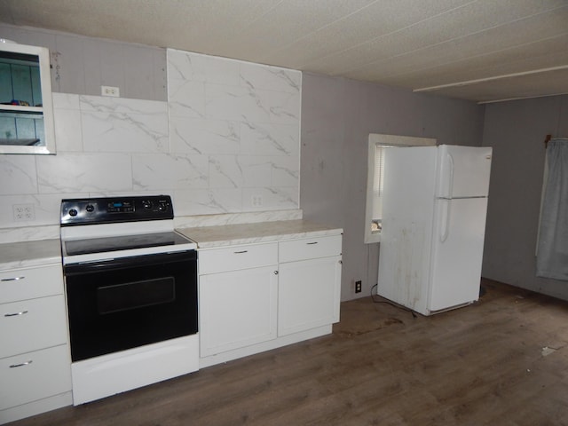 kitchen with white cabinets, dark hardwood / wood-style flooring, and white appliances