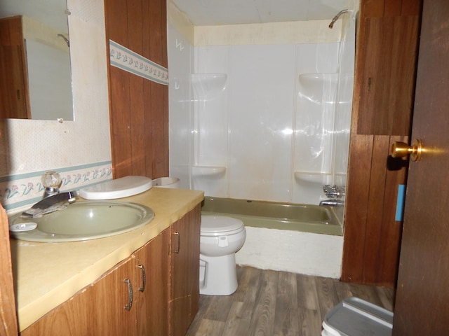 full bathroom with hardwood / wood-style floors, vanity, toilet, and shower / bath combination