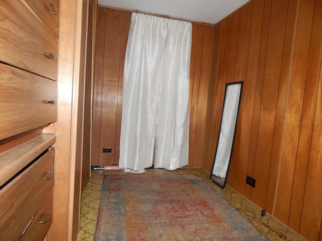 spare room with wood walls