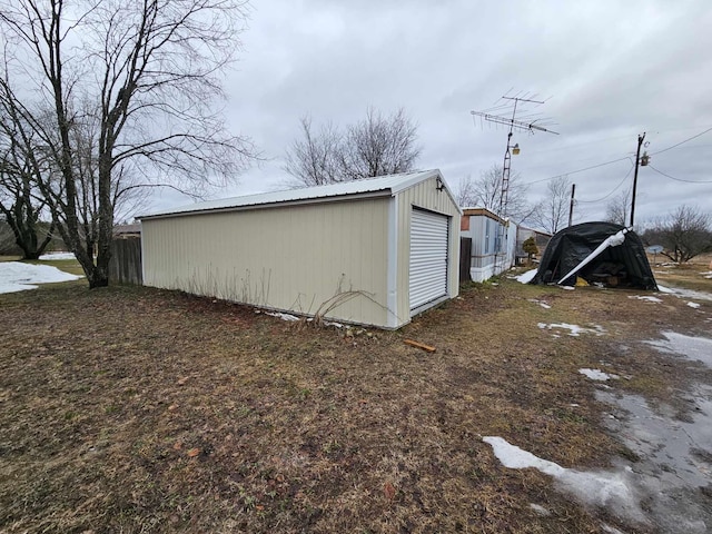 exterior space with a garage and an outbuilding