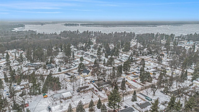 snowy aerial view with a water view