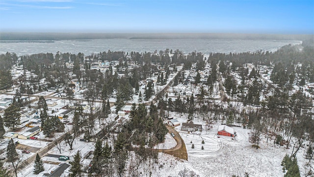 snowy aerial view with a water view