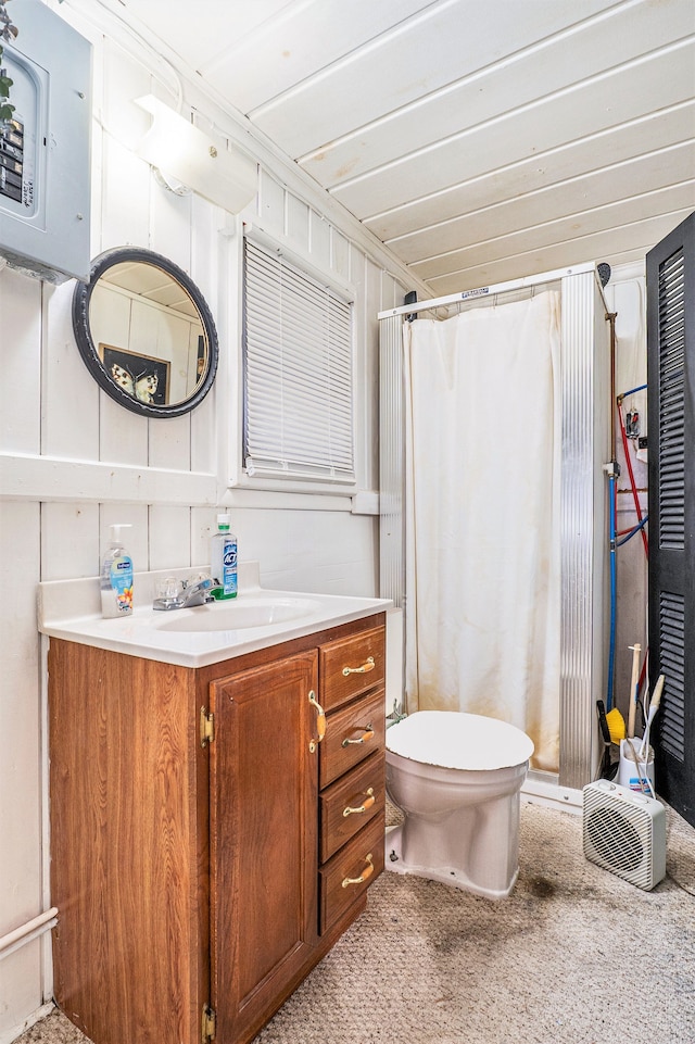 bathroom with vanity, toilet, ornamental molding, and walk in shower