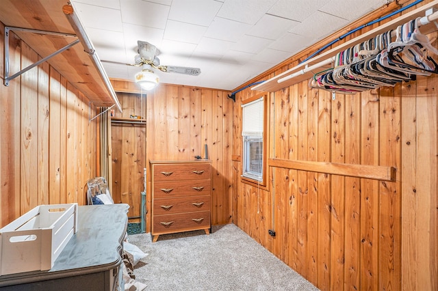 walk in closet with carpet and ceiling fan