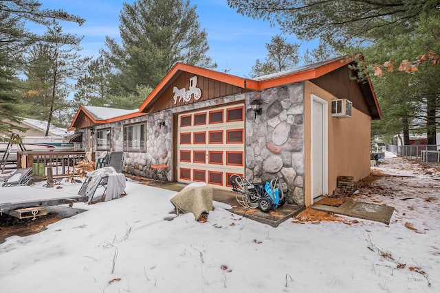 view of snow covered exterior with a garage