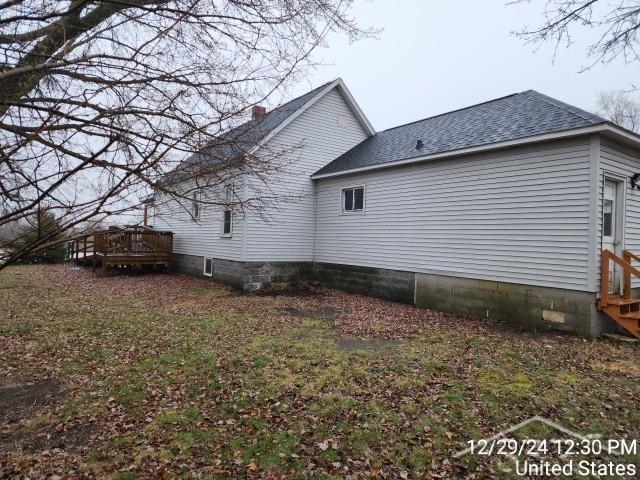 view of property exterior featuring a wooden deck