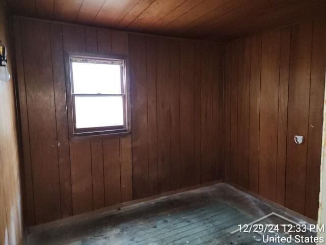 spare room featuring wood walls and wooden ceiling