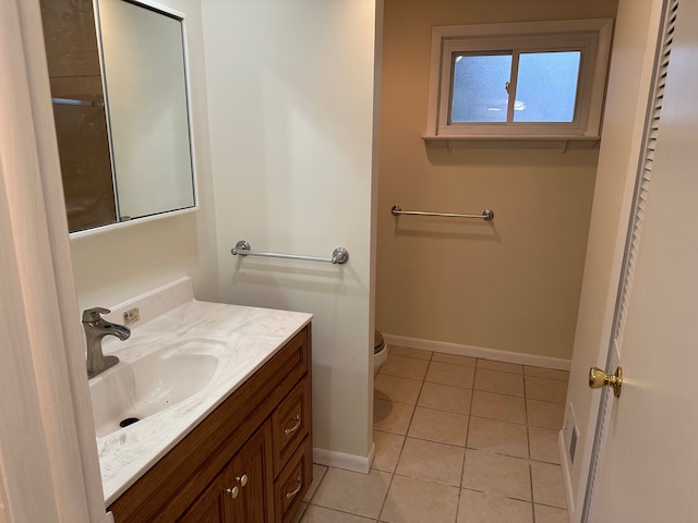 bathroom featuring vanity, tile patterned floors, and toilet