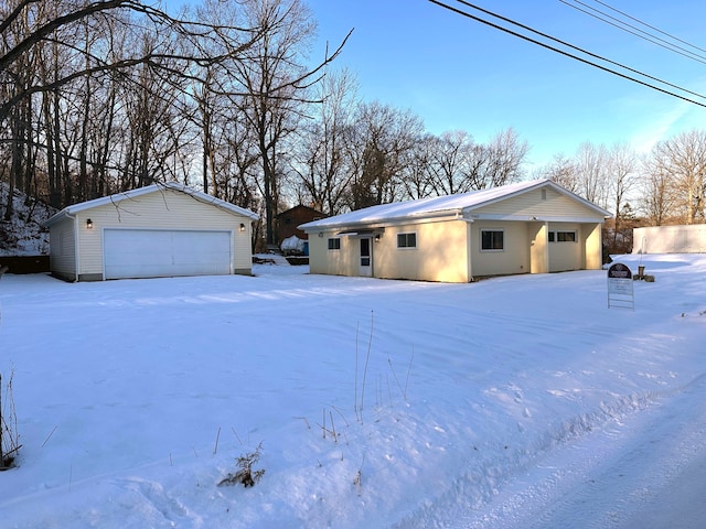 view of front facade featuring a garage and an outbuilding