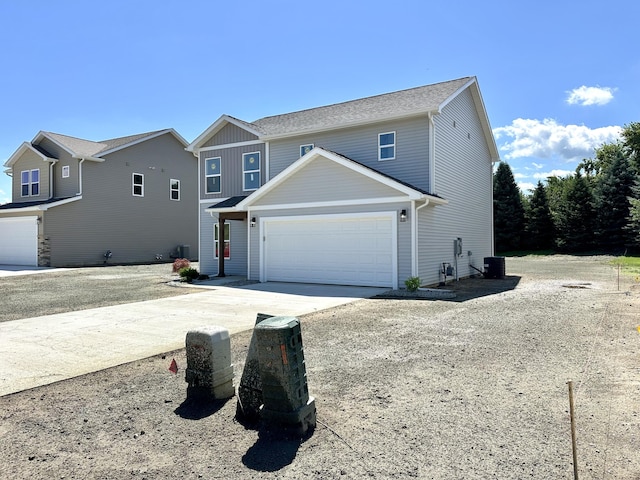 2011 Green Acres Dr, Adrian, MI 49221 - traditional home with a garage, driveway, and board and batten siding