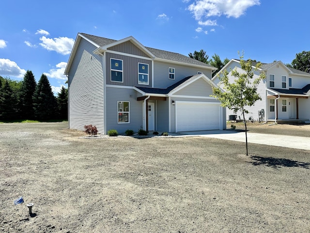 2011 Green Acres Dr, Adrian, MI 49221 - view of front of property featuring driveway, an attached garage, and board and batten siding