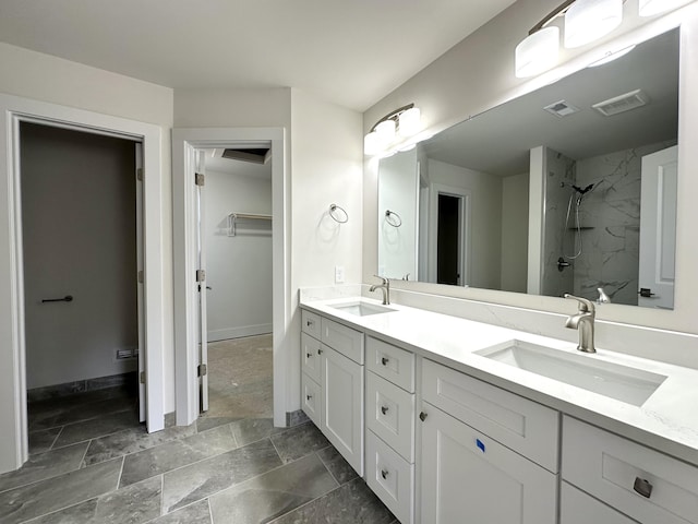 2011 Green Acres Dr, Adrian, MI 49221 - bathroom featuring double vanity, a marble finish shower, and a spacious closet