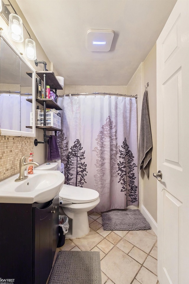 bathroom with decorative backsplash, vanity, and toilet