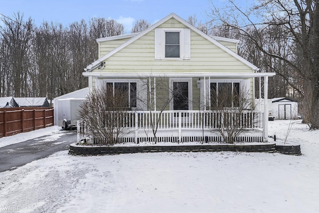 snow covered property with a storage shed