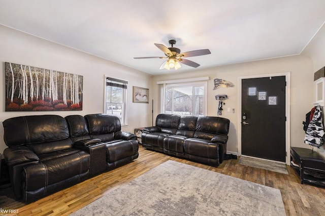 living room featuring hardwood / wood-style flooring and ceiling fan