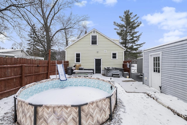 snow covered house with a hot tub