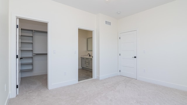 332 Arbor Ln, Saline, MI 48176 - unfurnished bedroom featuring a spacious closet, light colored carpet, a closet, and ensuite bath
