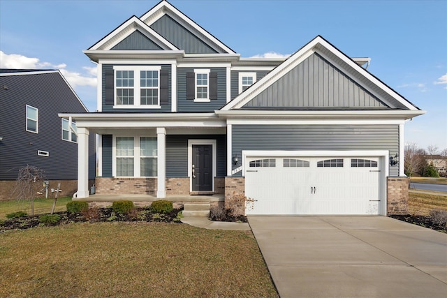 craftsman-style home featuring a front yard, a garage, and covered porch