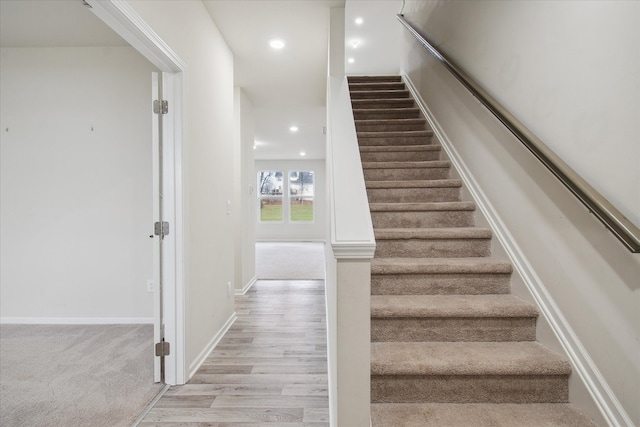 stairs featuring carpet flooring