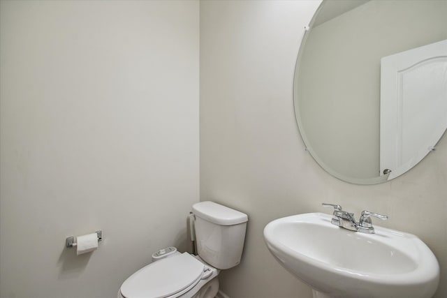 bathroom featuring toilet and sink