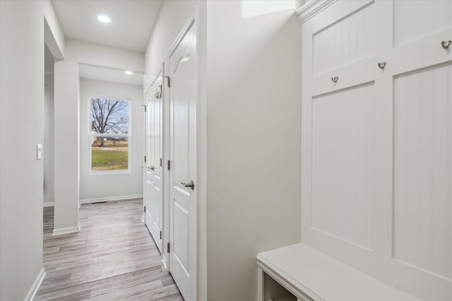 mudroom with light hardwood / wood-style floors