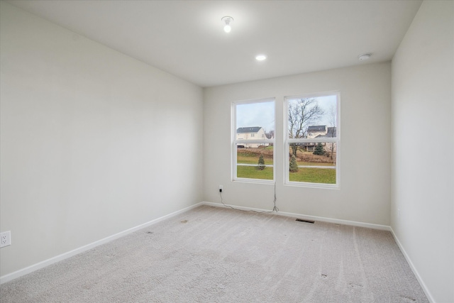 unfurnished room featuring light colored carpet