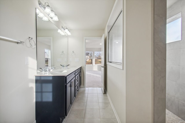 bathroom with tile patterned flooring, vanity, and a shower