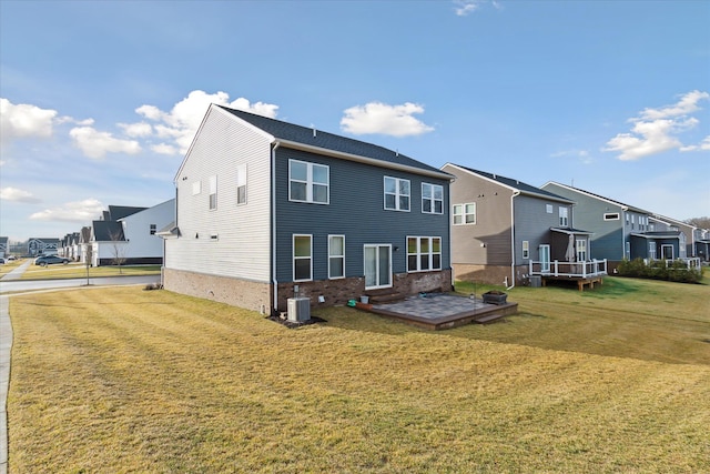 rear view of property with a yard and central AC unit