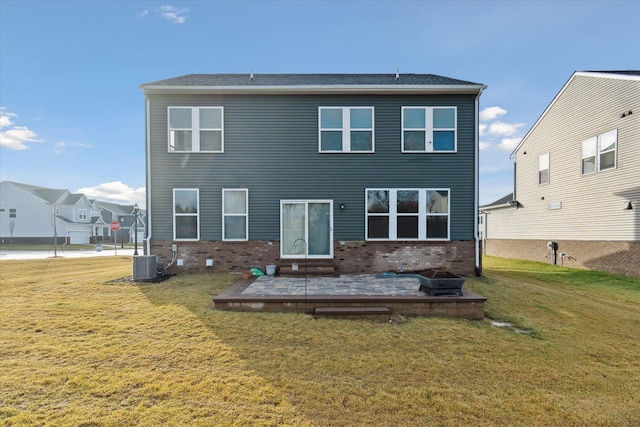 rear view of house with a lawn, central AC, and a patio