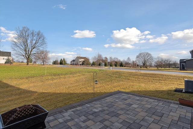 view of yard featuring central AC unit and a patio area